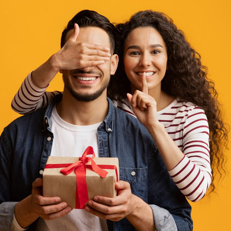Man getting present from woman, he holds the gift Funky Gifts NZ