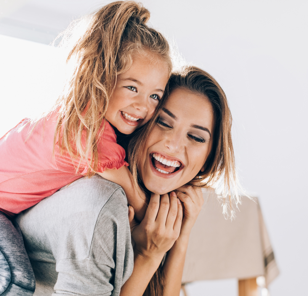 Mother and Daughter smiling and hugging
