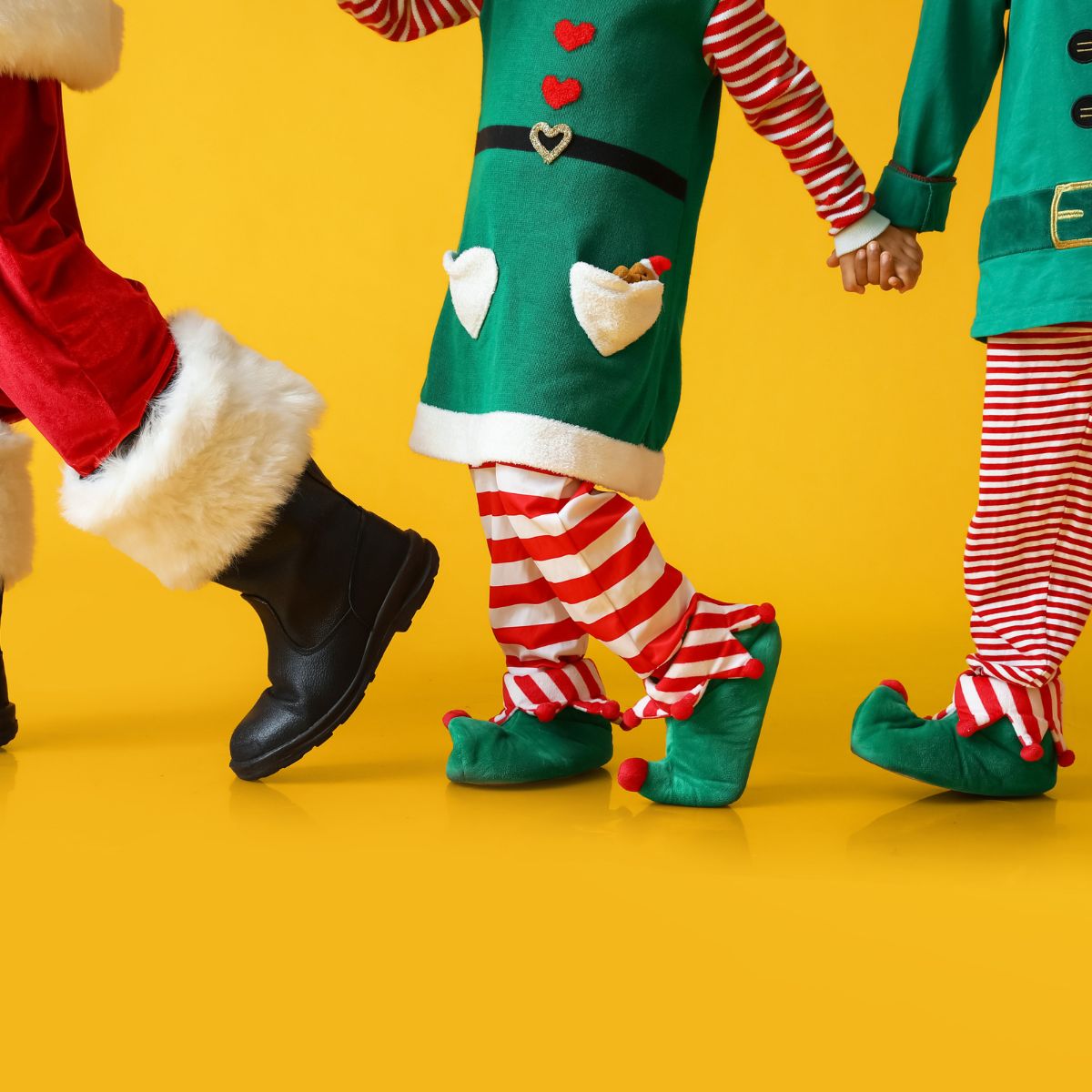 Santa and elves walking holding hands
