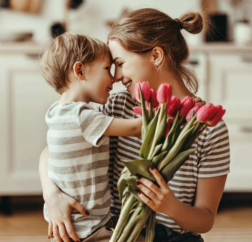 Child Giving Mother flowers and a hug