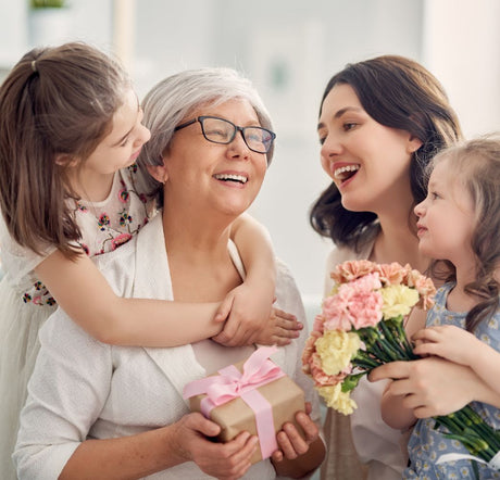 Kids, Mum and grandmother exchanging gifts on mothers day