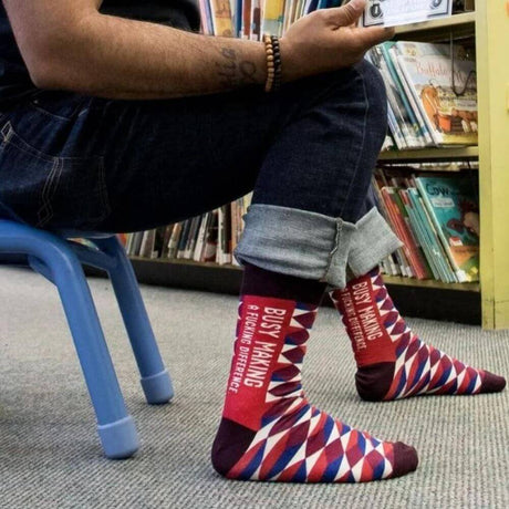 Man in library wearing blue q socks