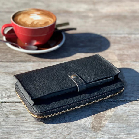 black wallet with coffee in background