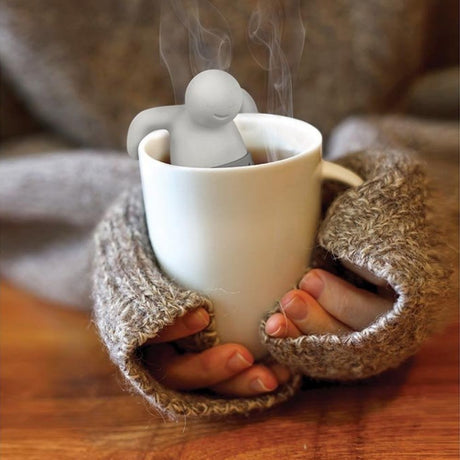 Woman holding hot cup of tea with mr tea tea insufer