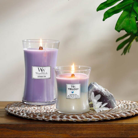 Woodwick candles burning one large and one medium on a side table