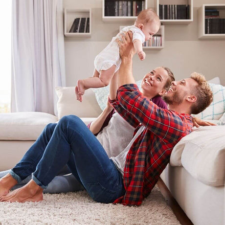 Parents looking up holding new baby