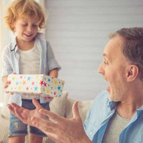 grandchild giving granddad a present