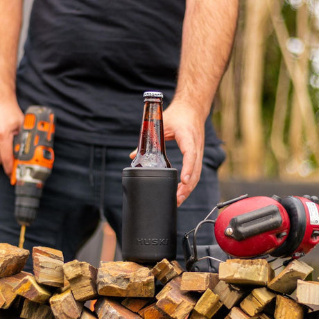 man with tools, wood and beer in beer cooler