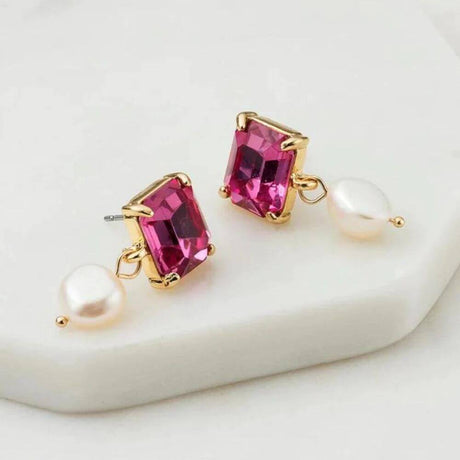 Pink gold earrings on a plate