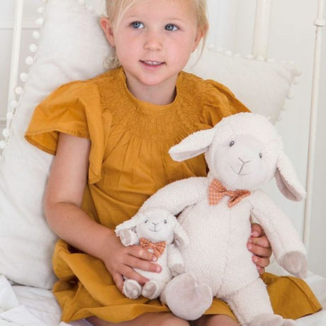 Girl in yello dress with two soft toy sheep