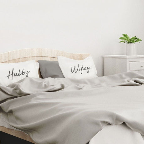 hubby & wifey pillow cases on bed