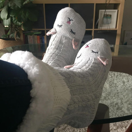 woman relaxing with snuggly cat reading socks