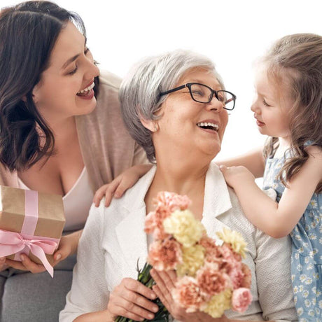 Gifts for grandma two grand daughters kissing grandmother